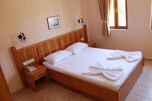 a bedroom with a bed with two towels on it at Nar Apart Hotel in Side