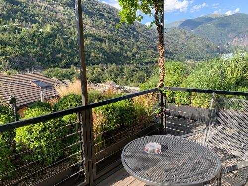 a balcony with a table and a view of a mountain at Ristorante della Stazione da YanElo in Intragna