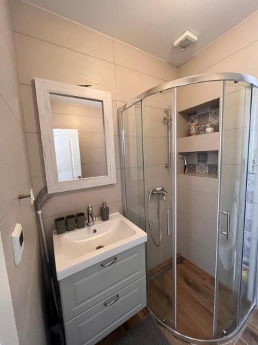a bathroom with a shower and a sink at Holiday Home Calma in Imotski