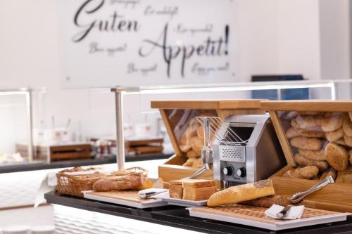 a bakery with bread and a toaster on a counter at City Hotel Stockerau in Stockerau