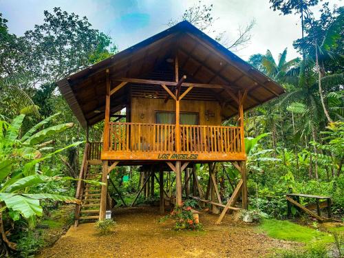 a tree house in the middle of a forest at Mama Yeya raíces in San Cipriano