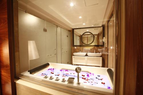 a bathroom with a bath tub with a key in it at Grand Plaza Hotel - Takhasosi Riyadh in Riyadh