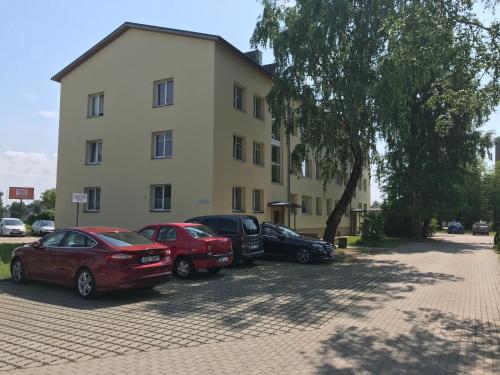 a group of cars parked in front of a building at Voyage apartment in Haapsalu