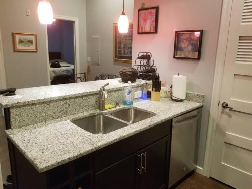 a kitchen with a sink and a counter top at #2BR-1BA Loft Downtown KC in Historic Building in Kansas City