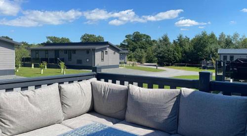 a couch sitting on the back of a balcony at Cairn Lodge in Woodhall Spa