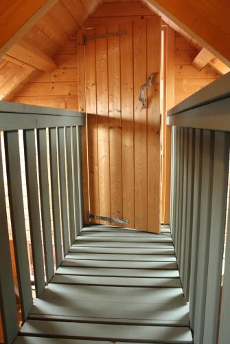 a staircase in a cabin with a wooden wall at COSY & NATURAL *FIREPLACE*GARDEN*2 BIKES in Heinenoord