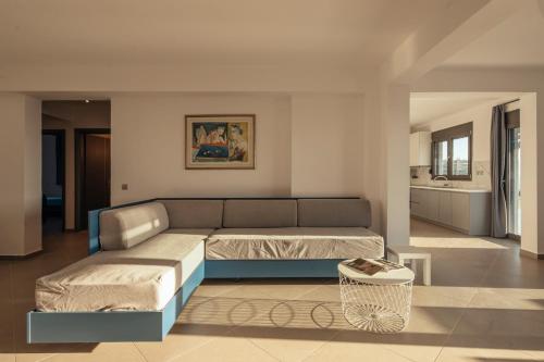 ein Wohnzimmer mit einem Sofa und einem Tisch in der Unterkunft ErMoJo Luxury Apartments in Metókhion Patriotikón