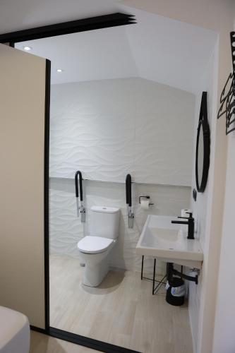 a bathroom with a toilet and a sink at Ca ma mare in Useras