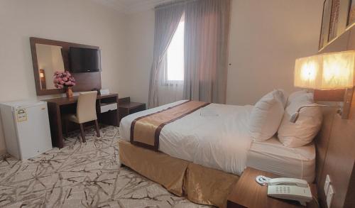 Een bed of bedden in een kamer bij فندق ربوة الصفوة 8 - Rabwah Al Safwa Hotel 8