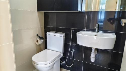a bathroom with a toilet and a sink at No.16 The Nordic @ Opposite Puchong IOI Mall in Puchong