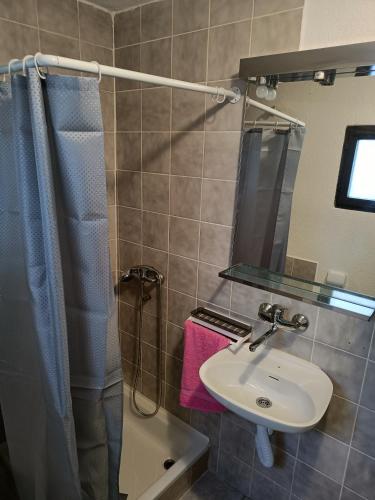 a bathroom with a sink and a mirror at Apartments Luka in Tisno