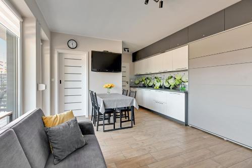 a living room with a couch and a table at APARTAMENTY PIAMOLA Willa Zacisze Kąty Rybackie in Kąty Rybackie