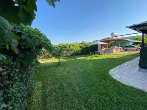 a yard with a house in the background at Tasos Cozy House in Lefkada