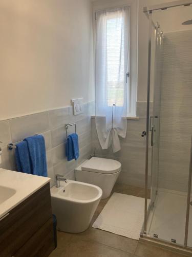 a bathroom with a toilet and a sink and a shower at B&B Il Melograno in Fano