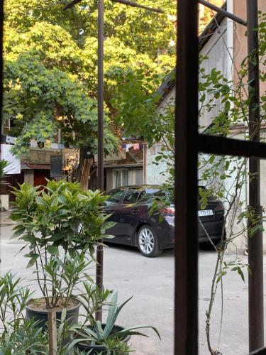 a car parked in a parking lot outside a window at Private House , in the middle of the city, in 10 min. To Fabrika in Tbilisi City