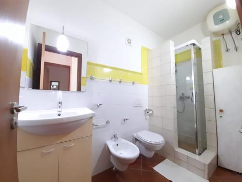 a bathroom with a sink and a toilet and a shower at Sal&Love apt in Porto Antigo in Santa Maria