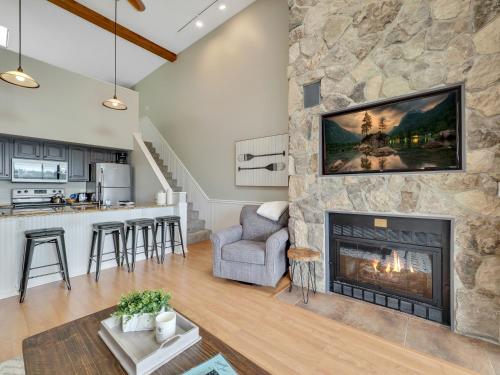 a living room with a stone fireplace at 357 Edgewater Inn in Charlevoix