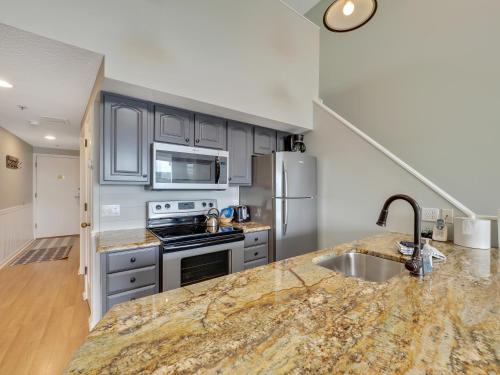 a kitchen with stainless steel appliances and a marble counter top at 357 Edgewater Inn in Charlevoix