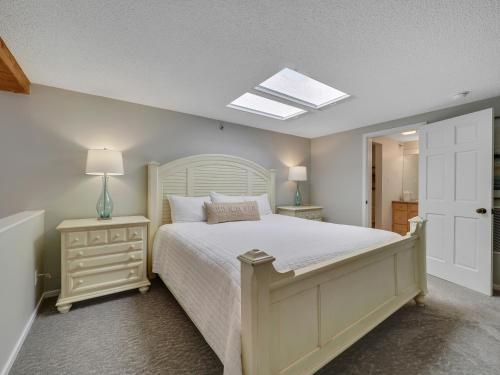 a bedroom with a large bed and a skylight at 357 Edgewater Inn in Charlevoix