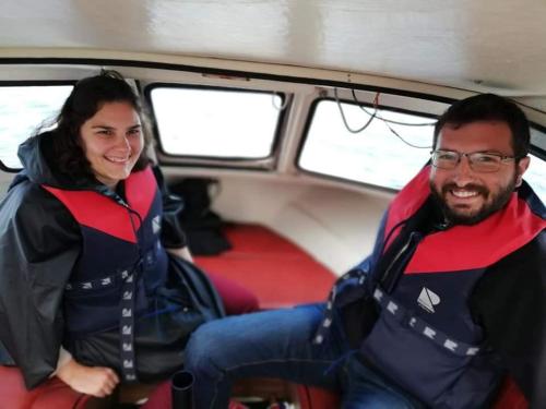 a man and a woman sitting in the back of a boat at Airbnb and Booking at Postvegen 95 in Vigra