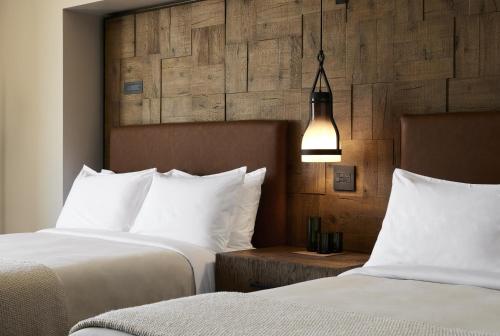 a hotel room with two beds with white pillows at 1 Hotel San Francisco in San Francisco