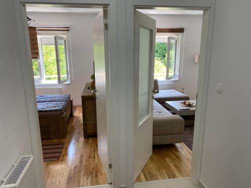 a living room with a door open to a living room at New Apartment in the City in Visoko