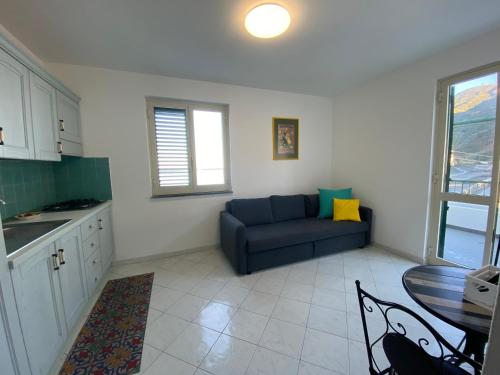 a living room with a blue couch and a table at CannetoMare in Canneto