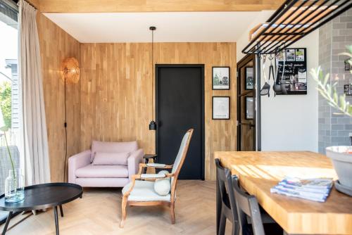 a living room with a table and a chair at Gîte81 in Reeuwijk