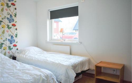 a bedroom with two beds and a window at Lovely Apartment In Tjörnarp With Sauna in Tjörnarp