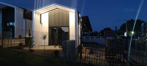a building with a light on the side of it at Zatoka Marina in Mechelinki
