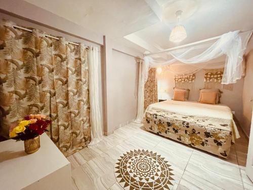 a bedroom with a bed and a vase of flowers at Villa Maimouna les pieds dans l'eau in Saint-Pierre