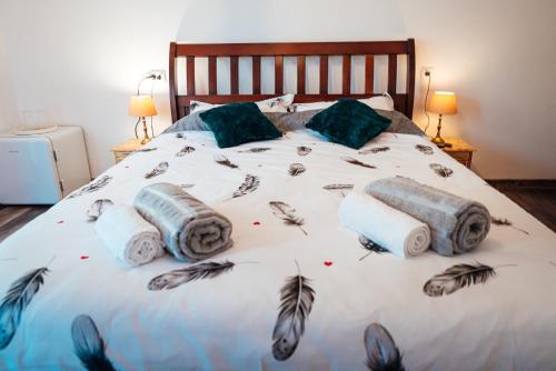 a bed with some pillows and feathers on it at Casa Sara in Turda