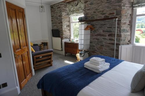 a bedroom with a bed with towels on it at Lake View Country House in Grasmere