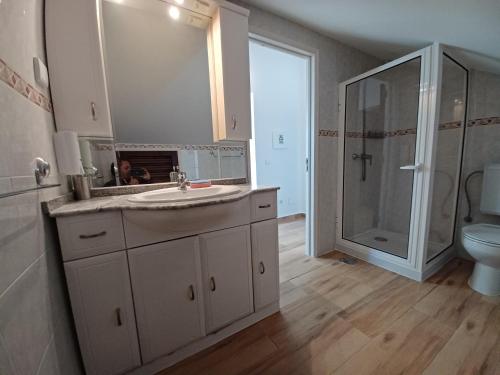a bathroom with a sink and a shower at VILLA CERRO E MAR Apartement in Moncarapacho