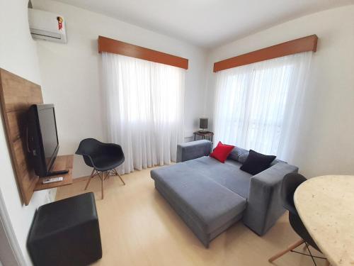 a living room with a couch and a tv at Flat INCRIVEL proximo Shoppings JK e Vila Olimpia in Sao Paulo