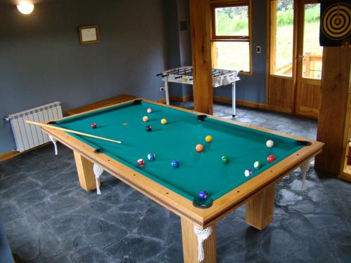 a pool table with balls on it in a room at Apart Hotel Altos de Antilhue in Villa La Angostura