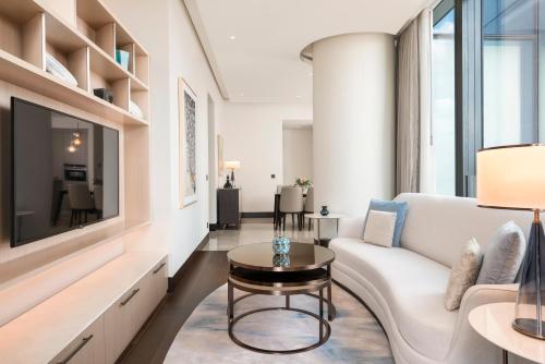 a living room with a white couch and a tv at Address Istanbul in Istanbul
