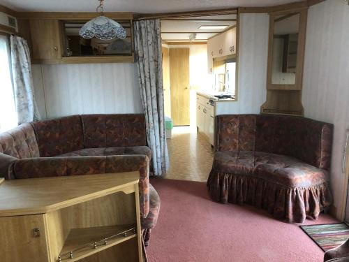 a living room with a couch and a table at Autocamp Skalice in Slapy