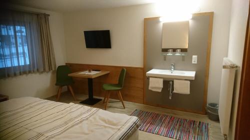 a hotel room with a bed and a sink at Ferienwohnung Höllwarth in Gerlos