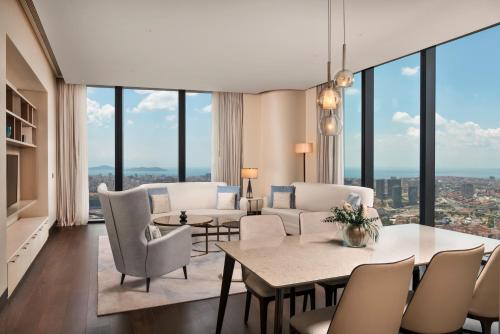 a living room with a couch and a table and chairs at Address Istanbul in Istanbul