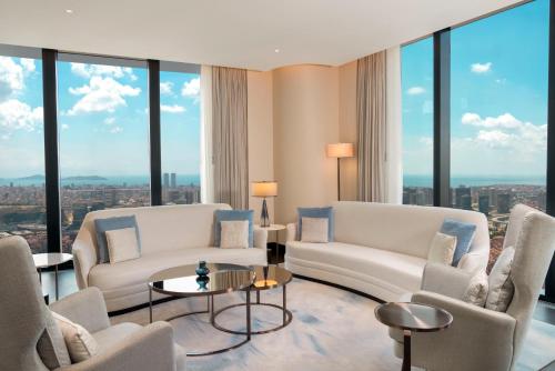 a living room with white furniture and large windows at Address Istanbul in Istanbul