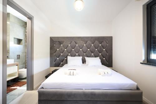 a bedroom with a large bed with two towels on it at Apartmani Bliss in Sukošan