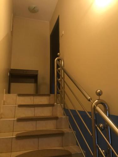 a set of stairs in a building with a door at Kaplarević Smeštaj Ivanjica in Ivanjica