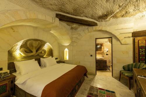 a bedroom with a large bed in a large room at Foremanson Cave Hotel in Nar