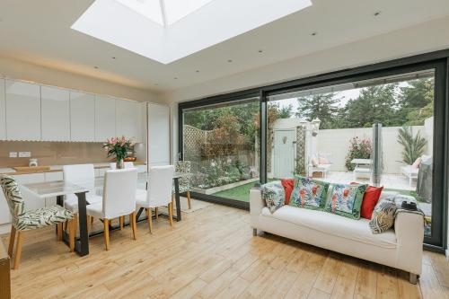 a living room with a white couch and a table at SWINTON HOUSE - Beautiful 3 Bed House in Harrogate, North Yorkshire in Harrogate
