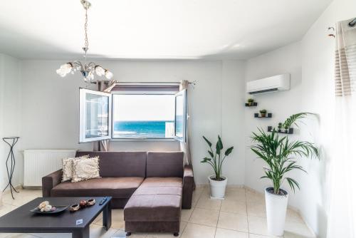 a living room with a couch and a table at Coastal Family House With SeaView in Heraklio Town