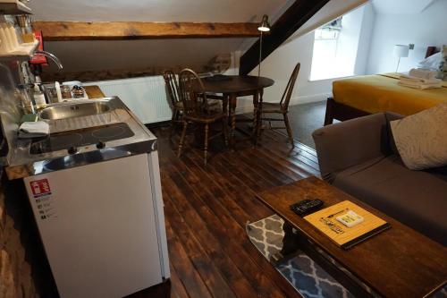 a kitchen and living room with a couch and a table at Lake View Country House in Grasmere