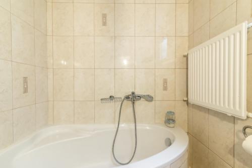 a bathroom with a bath tub with a shower at Coastal Family House With SeaView in Heraklio Town