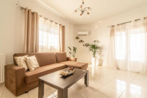 a living room with a couch and a table at Coastal Family House With SeaView in Heraklio Town