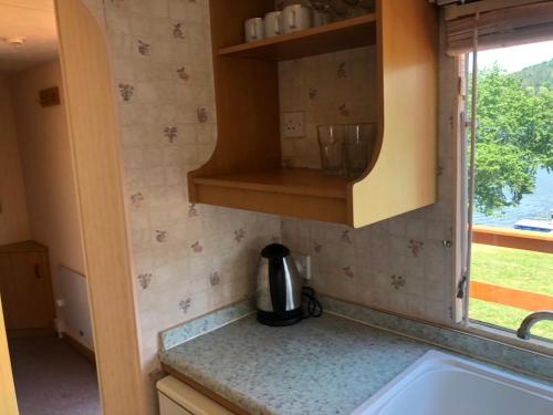 a kitchen with a sink and a counter top at Autocamp Skalice in Slapy